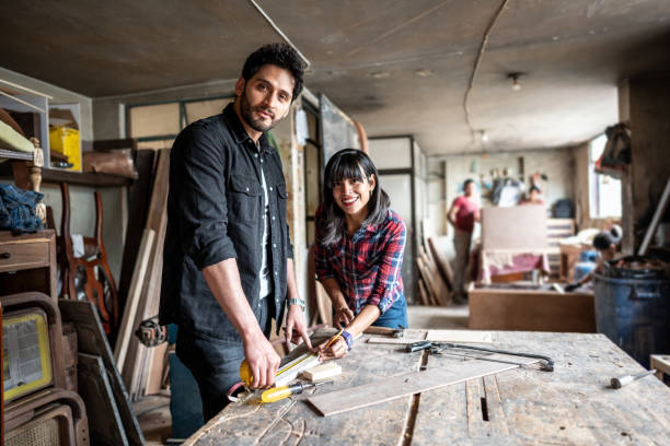 istock Portrait of coworkers working at carpentry workshop 1487156616