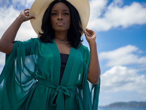 Confident attractive woman standing with beach cover up on a tropical beach, Scott Beach, St. John