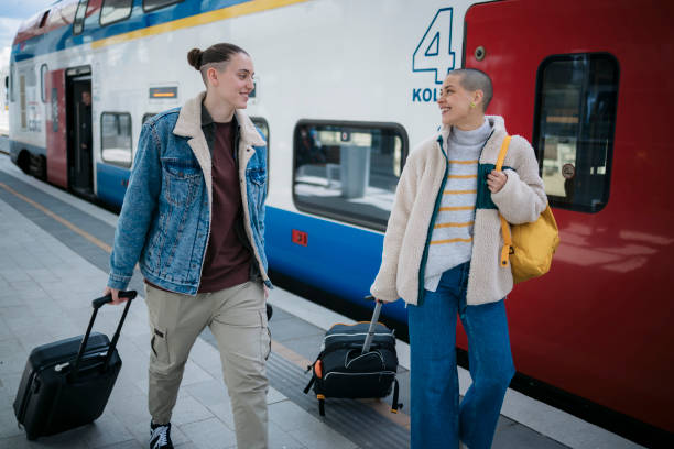 istock Female travelers going on vacation walking on railway stating platform 1487160633
