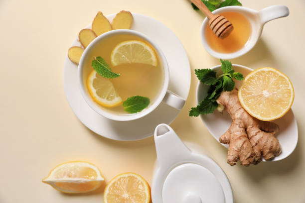 istock Delicious ginger tea and ingredients on beige background, flat lay 1487161066