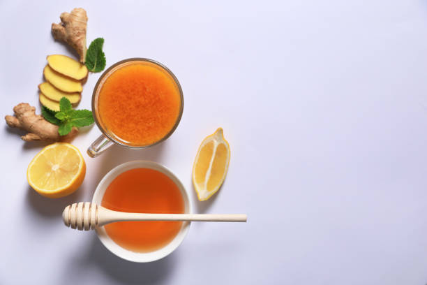 istock Delicious ginger tea and ingredients on white background, flat lay. Space for text 1487161325