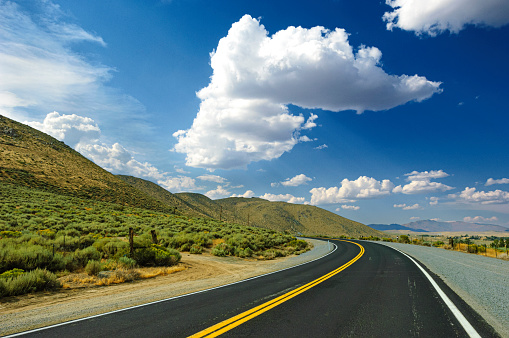 Remote desert road winding through sagebrush covered hills, under a cloudy sky.

Taken in Northern Nevada.