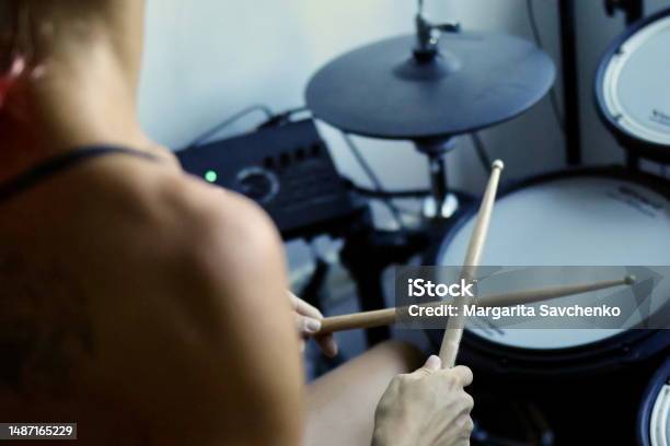 Young Woman Playing An Electronic Drum Kit Stock Photo - Download Image Now - Drum - Percussion Instrument, Learning, Musician
