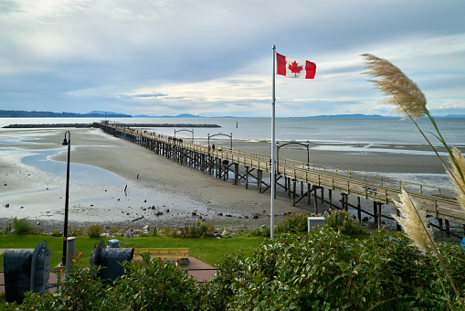 White Rock Pier on a cloudy day. White Rock is a popular tourist destination on the west coast of British Columbia.