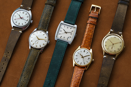 Medium group of vintage wrist watches on brown leather