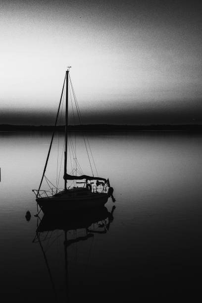 A sailboat at rest in the early morning hours on Lake Wissota in Chippewa Falls, WI