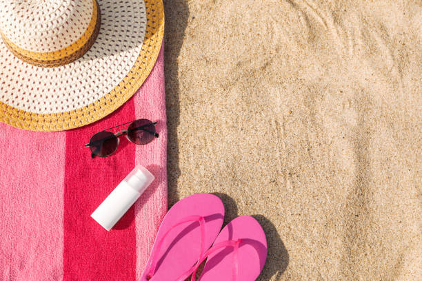 istock Towel and beach accessories on sand, flat lay. Space for text 1487170506