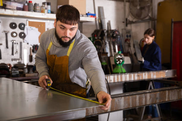 istock Skilled man  worker working with measuring tape 1487170719