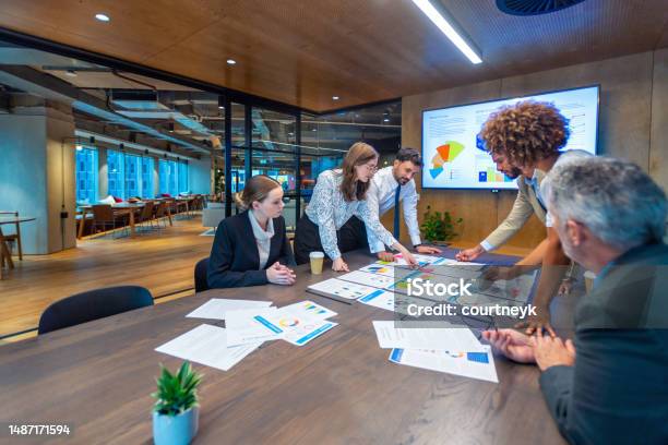 Paperwork And Group Of Peoples Hands On A Board Room Table At A Business Presentation Or Seminar Stock Photo - Download Image Now