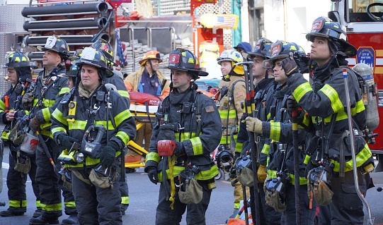 New York City firefighters waiting on standby at a reported apartment fire in a 5-story residential apartment building in lower Manhattan.