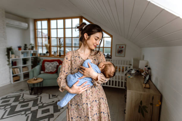 istock Young mother puts baby to sleep 1487172872
