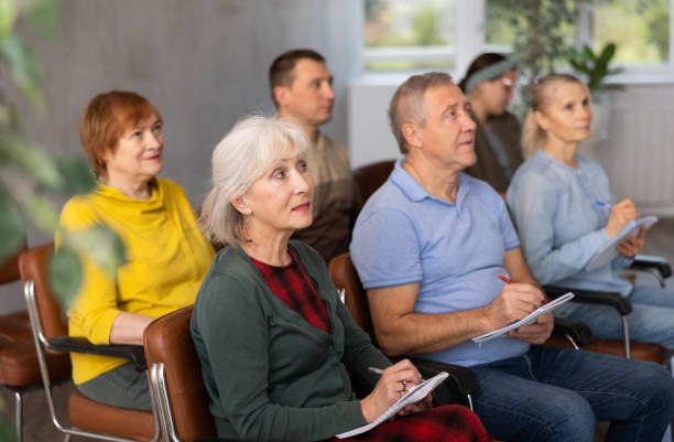 istock Adult students listening in classroom university 1487172944