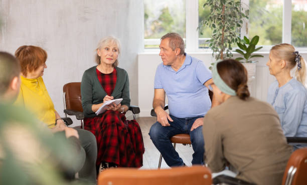 istock Elderly female tutor teaching language to group of mature students 1487172982