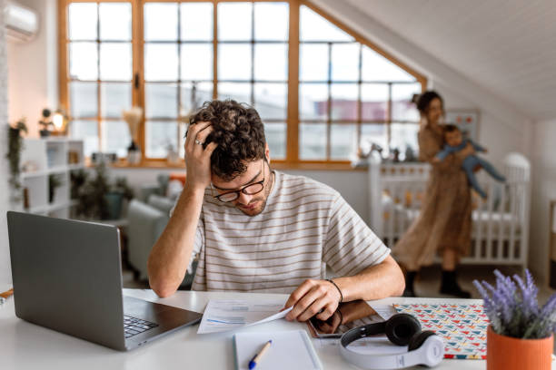 istock Young family doing financial planning at home 1487173103