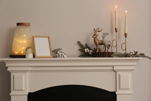 istock Stylish interior decorations on fireplace near white wall indoors 1487173116