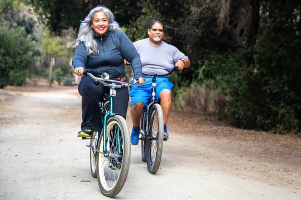 istock Senior Mexican Couple Riding Bicycles 1487173346