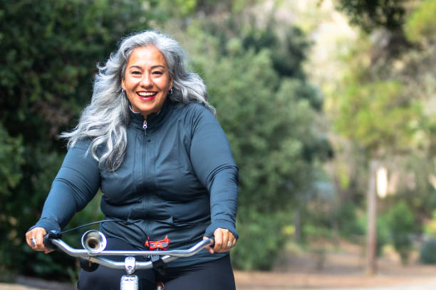 istock Senior Mexican Woman Riding Bicycle 1487173355