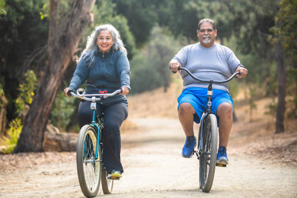 istock Senior Mexican Couple Riding Bicycles 1487173365