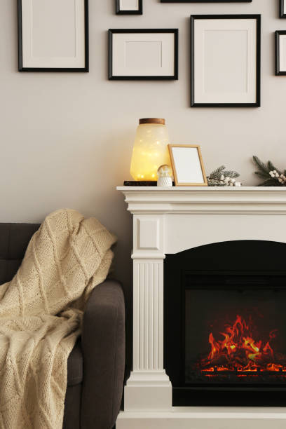 istock Stylish interior decorations on fireplace near white wall indoors 1487173367