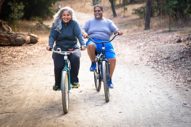 istock Senior Mexican Couple Riding Bicycles 1487173371