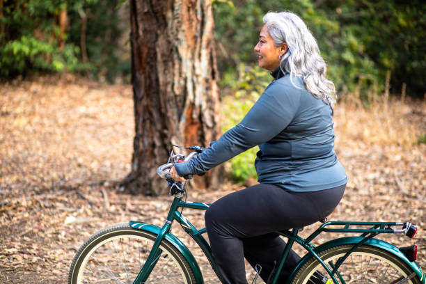 istock Senior Mexican Woman Riding Bicycle 1487173376