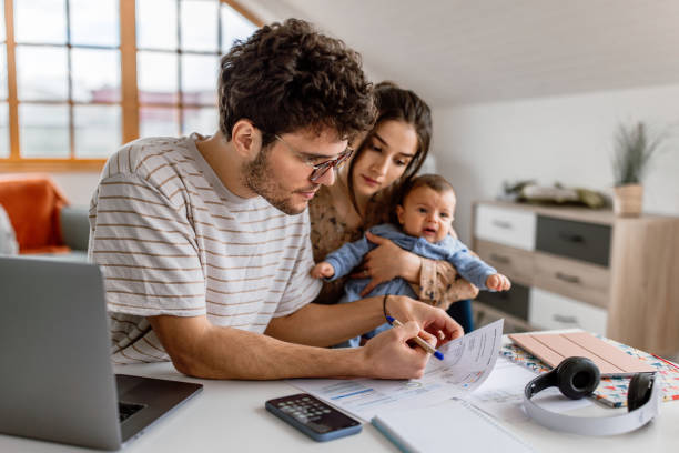 istock Young parents planning finances at home 1487173382