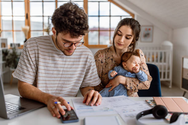 istock Young parents planning finances at home 1487173387
