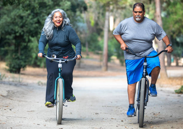 istock Senior Mexican Couple Riding Bicycles 1487173397