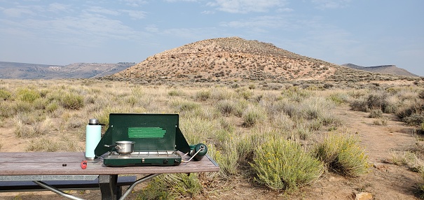 This is a photograph taken on a mobile phone of a camp stove setup outdoors in Curecanti National Recreation Area in Gunnison, Colorado during autumn of 2020.