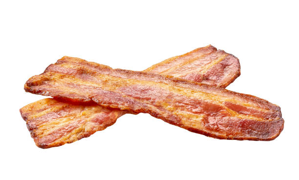 istock two fried bacon strips isolated on white background. bacon isolated on white background. Crispy  fried bacon pieces close up. 1487176310