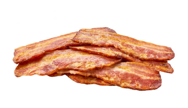 istock pile of fried bacon strips isolated on white background. 1487176363