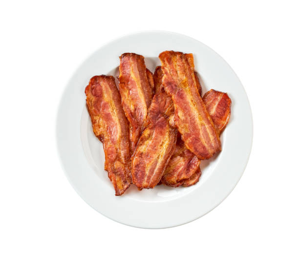 istock white plate with fried bacon isolated on white background. Top view. Plate with fried bacon on white background. 1487176432