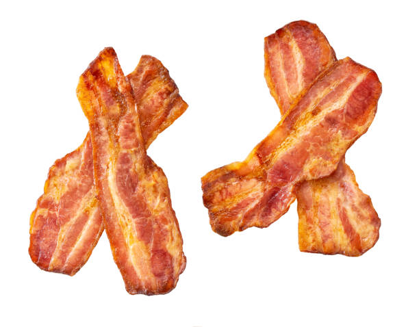 istock two fried bacon strips isolated on white background, top view. Crispy smokey fried bacon slice or strip. 1487176449