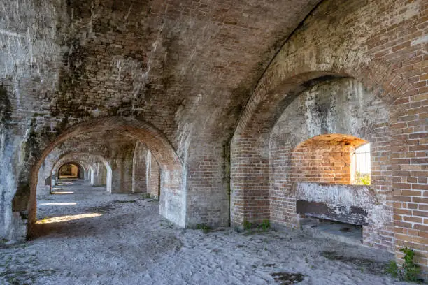 Limestone leaks onto the brick arches and walls of an exterior casemate in historic Fort Pickens in Gulf Islands National Seashore near Pensacola Beach, Florida.
