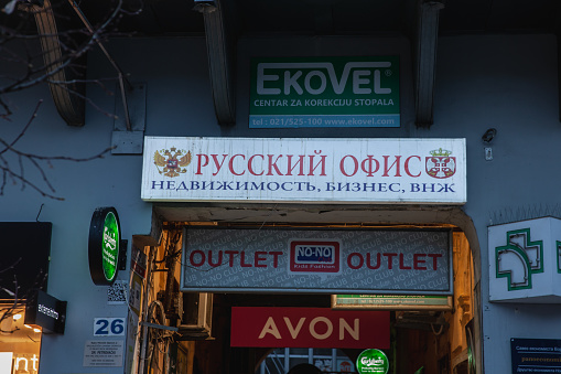 Picture of a sign of a law firm of Novi Sad, Serbia, Russian Office, specialized in russian emigration and immigration to Serbia. Russians started to move to Serbia as a result of the war in Ukraine.