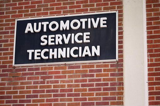 Close up of automotive service technician sign on building exterior