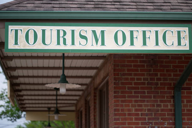 istock Tourism office sign handing from building 1487184715