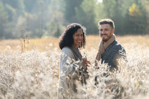 istock A romantic walk of lovers on the grass. 1487185746