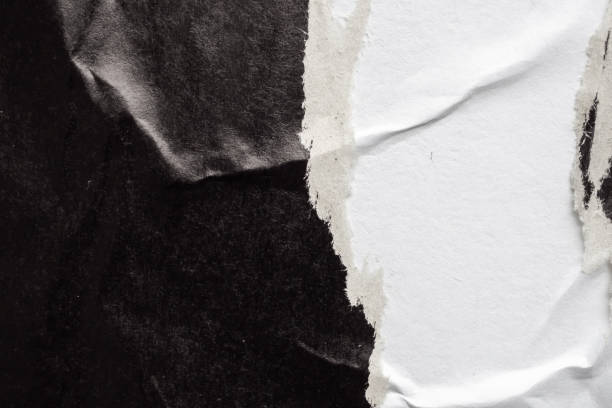 istock Old grunge ripped torn black paper poster surface texture background 1487185875