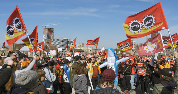 Protesters holding signs during a demonstration in the street