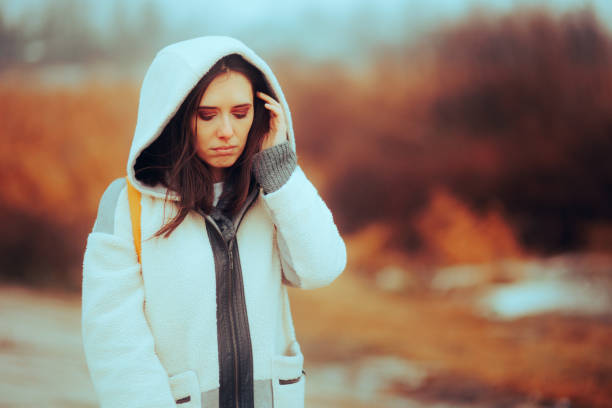 Sad Woman Suffering During Cold Season Feeling Unhappy Stressed unhappy lonely person walking in wintertime seasonal affective disorder stock pictures, royalty-free photos & images