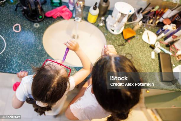 Big Sister Little Sister Learning To Brush Teeth Together Stock Photo - Download Image Now
