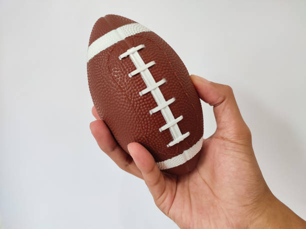 istock Hand holding rugby ball 1487202194