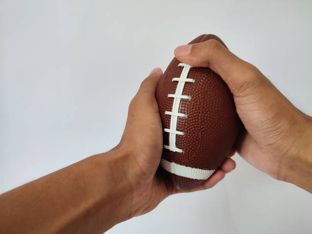 istock Hand holding rugby ball 1487202231
