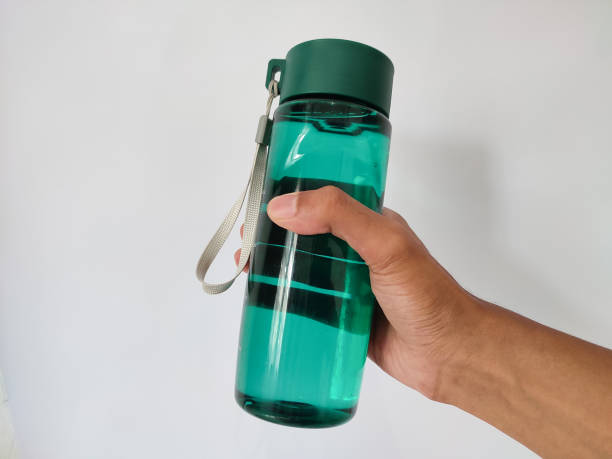 istock hand holding plastic bottle filled with water 1487202243