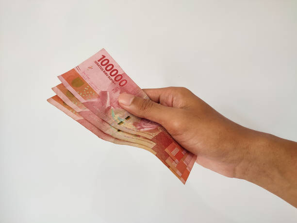 istock Hand giving money on isolated white background 1487202316
