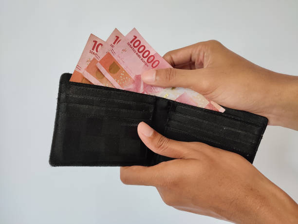 istock Hand taking money from wallet 1487202450