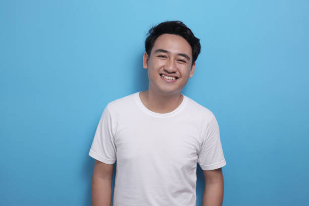 istock Happy young Asian man smiling at camera 1487202483