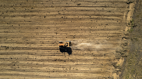 Top down shot of a tractor plowing and preparing the soil for planting. Farming in the Karoo requires hard work and dedication