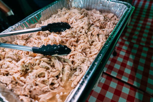 istock A Large Aluminum Roasting Steam Table Pan Full of Delicious Pulled Chicken Breast for BBQ with Serving Tongs, Part of a Professionally Catered Meal in the Southern USA. 1487210186